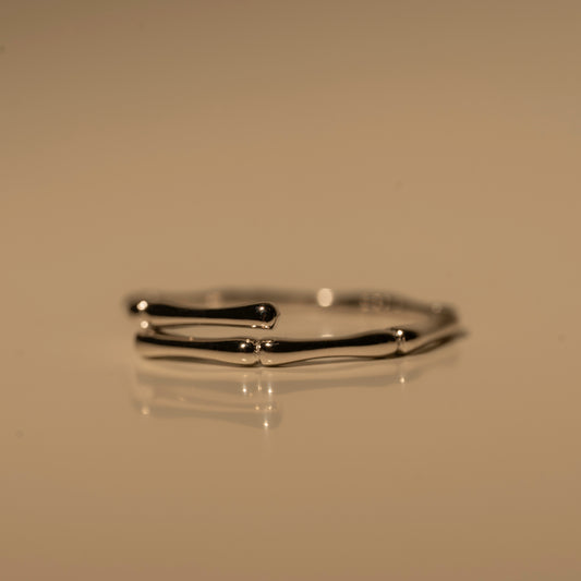 Close-up of Milk & Rose Dainty Bamboo Ring, showing the open ends and bamboo-inspired segments of the slim band.