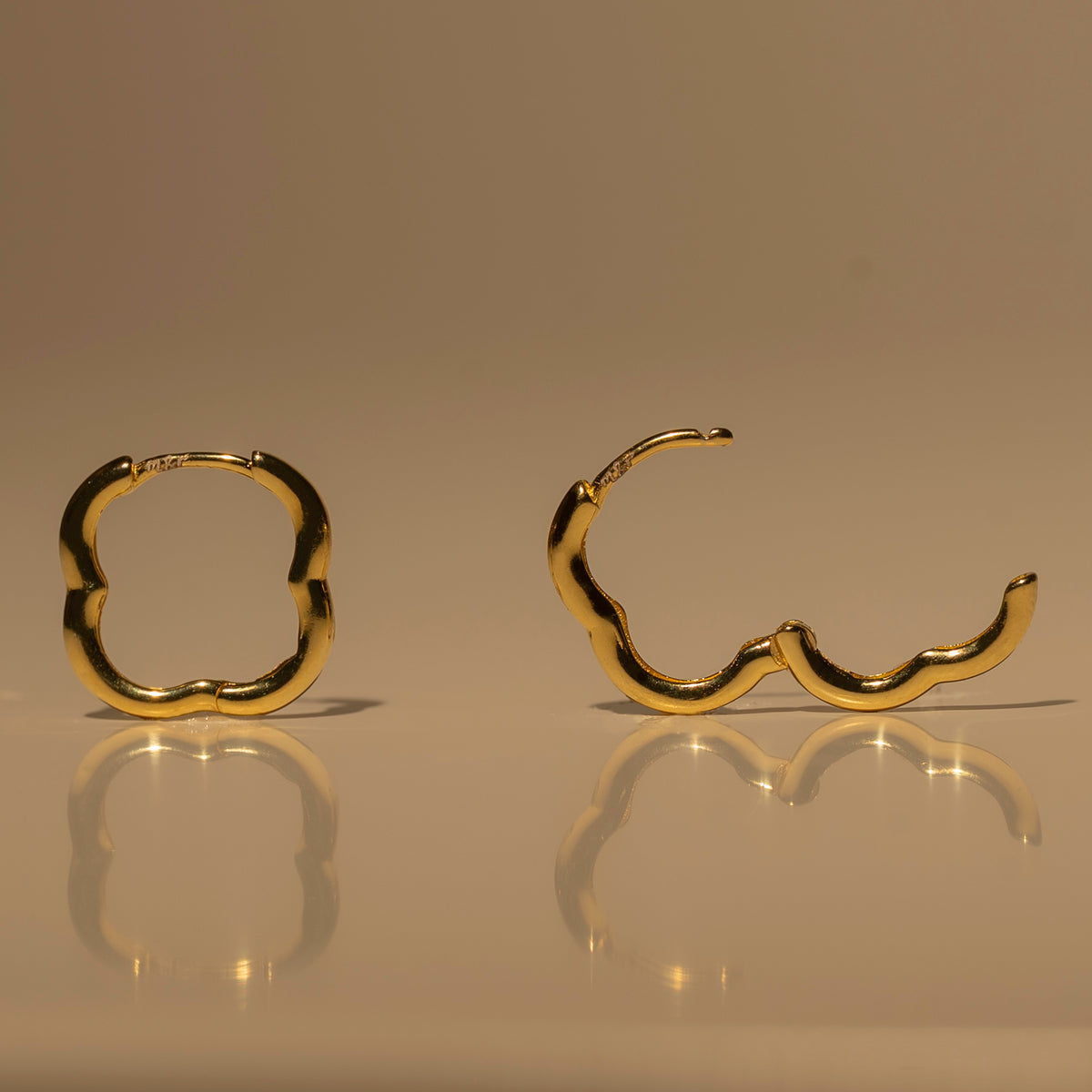 Milk & Rose Fleur Hoops in a gold tone, showing scalloped flower outlines from the front and side.