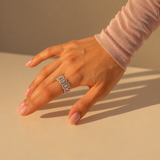 Milk & Rose Super Glam Ring worn on a hand in sunlight, showing its wide oval-link design and clear stones.