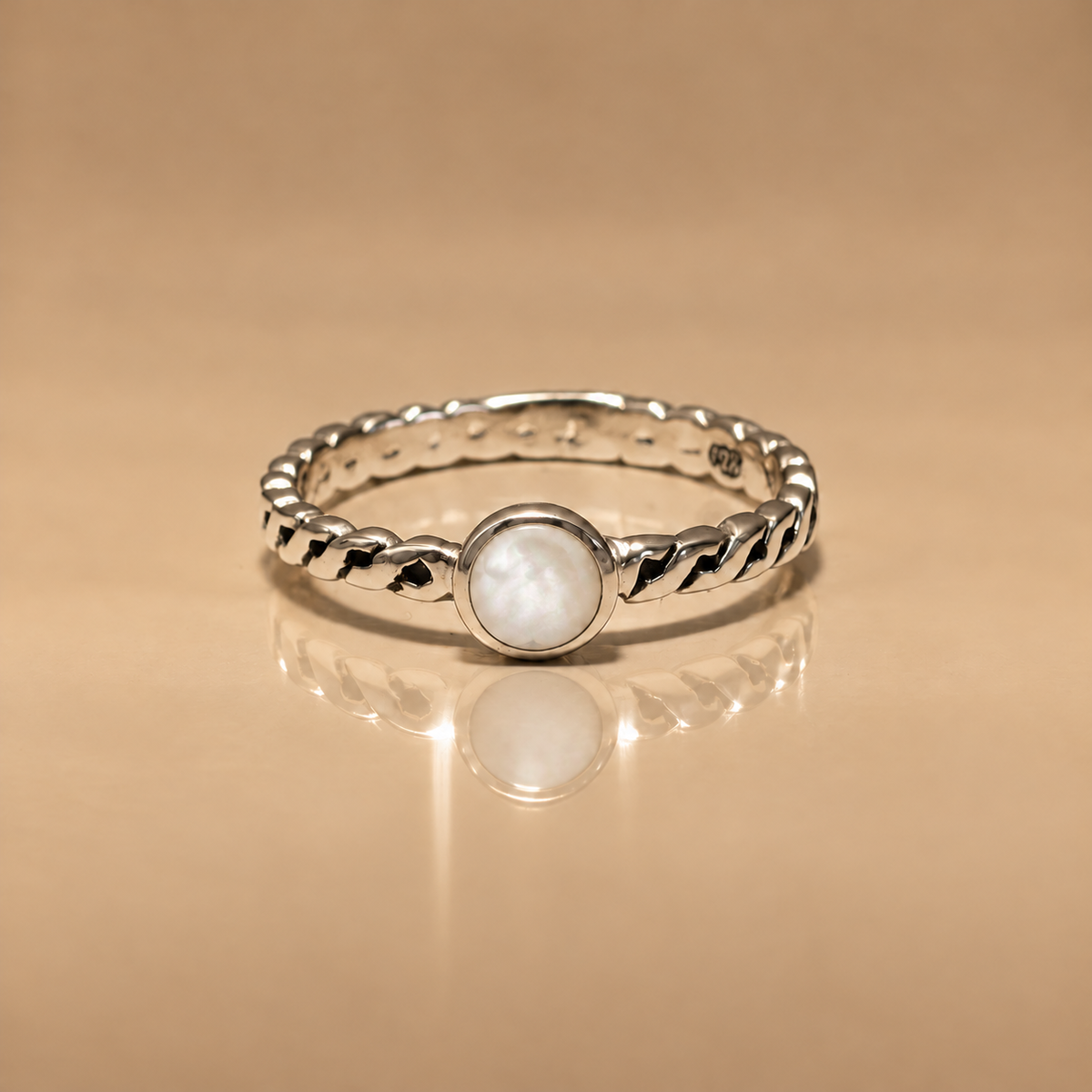 Ribbon Pearl Ring, sterling silver braided band with a round mother of pearl stone