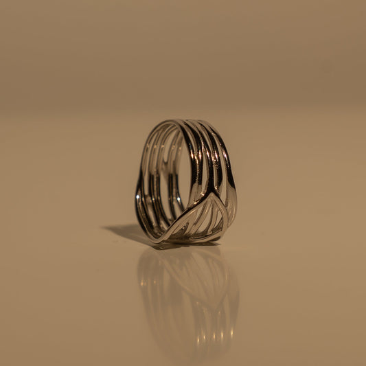 Forest Ring standing upright, showing the side profile of its wide silver-tone openwork band.